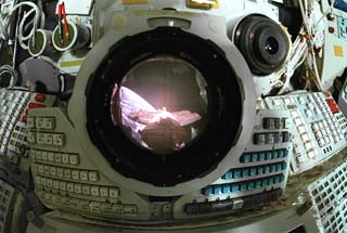 View looking through Mir Space Station Base Block periscope with the Spektr module and Earth limb in view. 